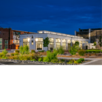 Front entrance view of a newly renovated white train yard building.