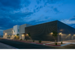 Exterior view of the Chevron Field Office in the evening with exterior lights on. 
