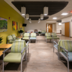 Waiting room with side tables and green chairs at Presbyterian Clinic at San Mateo.