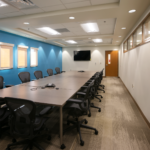 Conference room with black chairs and a blue accent wall at the Presbyterian Clinic at San Mateo.