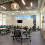 open space at UNM HSC with tables and chairs.